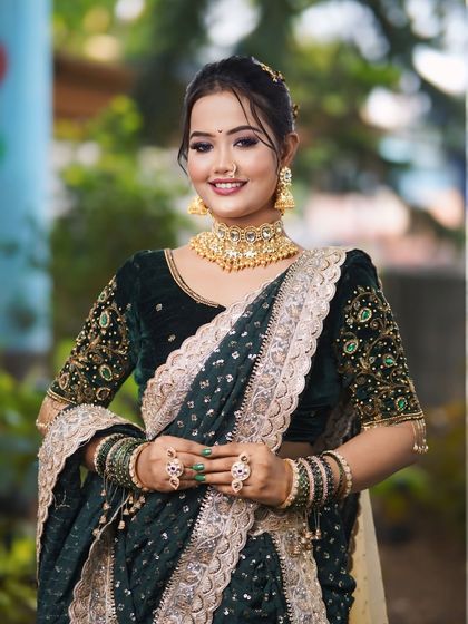 A full-length view of the festive green saree look. The makeup is designed to be bold and beautiful, ensuring you stand out at any event.
