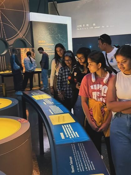 Curiosity in action. The team gathered around an exhibit, learning about science and history.