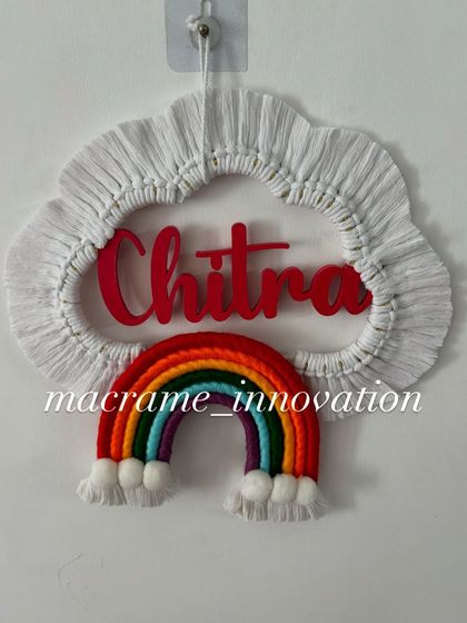The "Chitra" name hanging without the lights on, showing the vibrant colors of the rainbow in natural light.