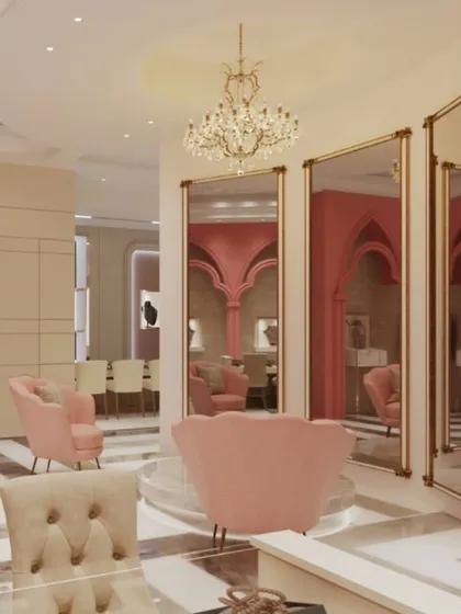 A private seating area within a jewelry showroom, designed for intimate consultations. We used large, gold-framed mirrors to enhance the sense of space and reflect the blush pink tones of the decor, creating a chic and exclusive feel.