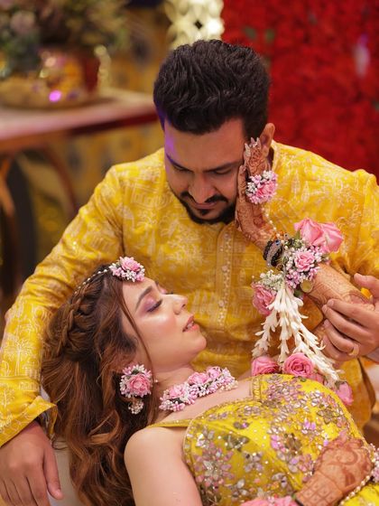 A candid moment from my haldi ceremony. The makeup is soft and floral, designed to look fresh and radiant, perfectly matching the yellow outfit and floral jewelry for this pre-wedding function.