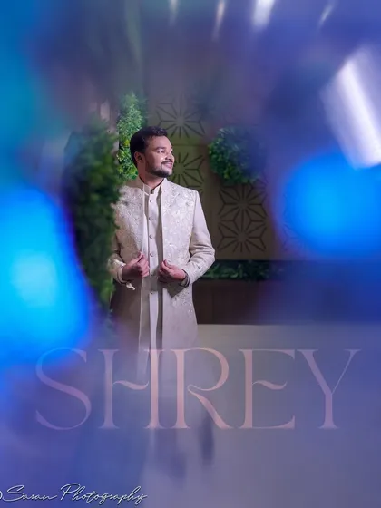 An artistic portrait of the groom with a blue light leak effect, creating a modern and stylish look.