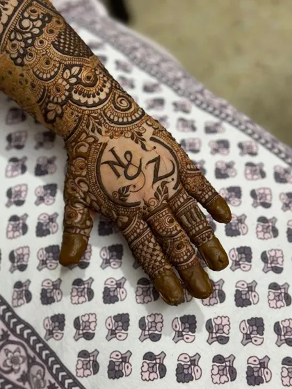 For this couple's engagement, I designed a custom monogram with their initials 'N & Z' as the centerpiece of the palm.