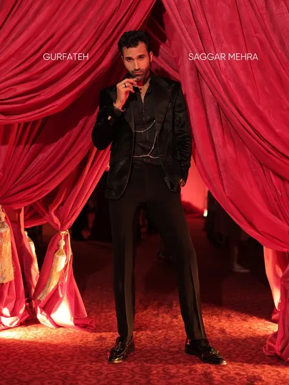 This look for Gurfateh Pirzada is an exercise in texture and mood. The black textured velvet coat, paired with an all-black ensemble and chain detail, is designed to be a definitive statement piece for evening wear, exuding luxury and confidence.