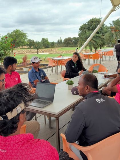 The collaborative spirit of our team is our foundation. Here, coaches from different specialties discuss an athlete's development plan.