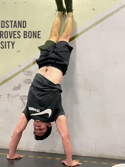 The handstand is more than just a cool party trick. It's a weight-bearing exercise that improves bone density, particularly in the wrists, arms, and shoulders.
