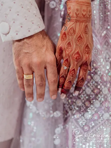 It all begins with this. A close-up of the engagement rings and intricate henna design, symbolizing the start of a new journey. I focus on these meaningful details that hold so much significance.