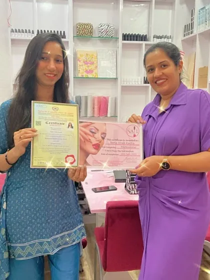 This student is now a double-certified nail technician, holding both her course completion and government-approved certificates.