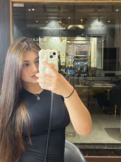 A selfie of the client with her new hair color, showing how much she loves her transformation.