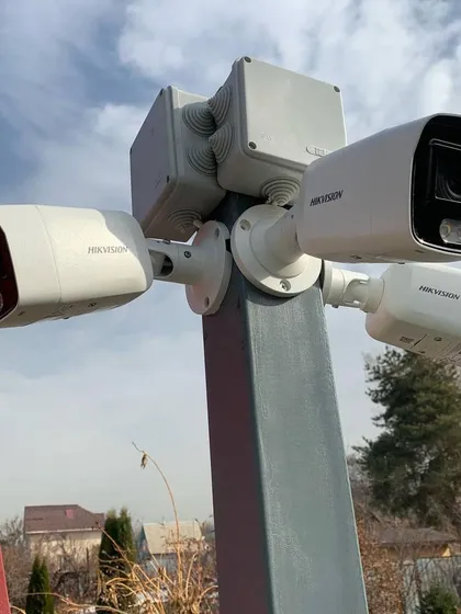 For larger properties and commercial spaces, we design and install multi-camera systems for comprehensive coverage. This pole-mounted setup features multiple Hikvision cameras to monitor a wide area from a single point.