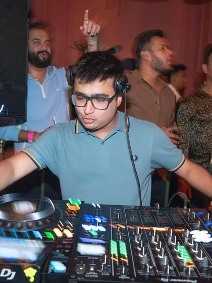 A motion-blurred shot showing my focus on the decks while the party rages around me.