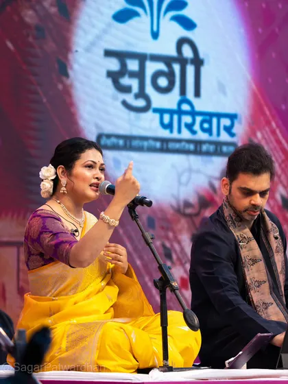 A shot showing the festive stage setup and Priyanka Barve with her fellow musician.