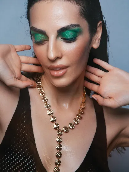 I am never afraid to play with bold color. Here, I created a striking emerald green glitter eyeshadow look, blended out for a smoky effect. Paired with a glossy nude lip and dewy skin, this is a great example of a high-impact editorial makeup look.