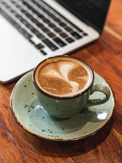 A close-up of a cappuccino with beautiful latte art, a perfect companion to our breakfast menu.