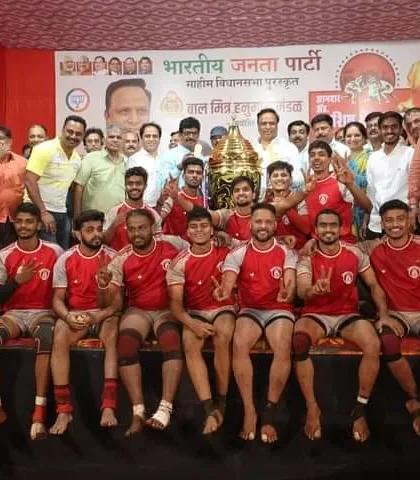 Victorious at the "Aamdar Adv. Ashish Shelar Chashak" tournament, posing with the trophy on stage.