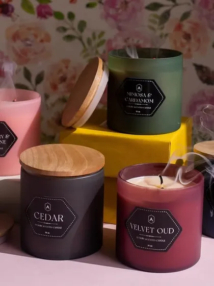 A soirée of scents from our Festive Collection. After being lit, the smoke gently rises from these frosted glass candles, leaving behind fragrances like Velvet Oud and Strawberry & Champagne.