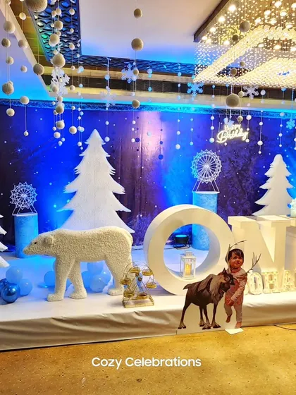 I love creating elaborate fantasy worlds, like this "Winter ONEDERLAND" first birthday. The entire stage is transformed with snowflake-dusted trees, life-sized polar bear props, and cool blue lighting for a magical winter experience.