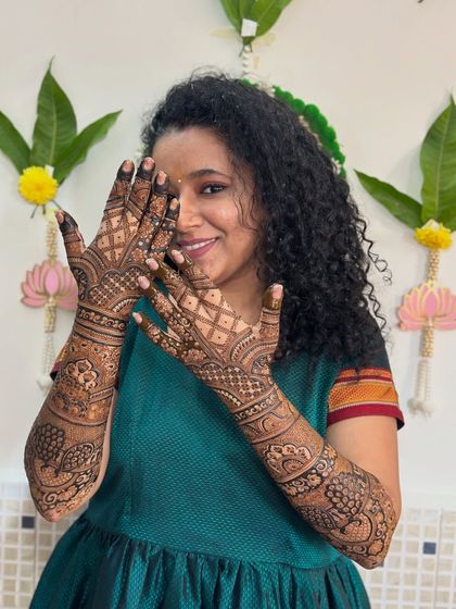 A lovely portrait of the bride, with her intricate mehendi as the perfect accessory.