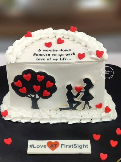 A sweet cake to celebrate a 6-month anniversary. This design features a romantic silhouette of a couple under a tree of hearts, with the message "6 months down, forever to go."
