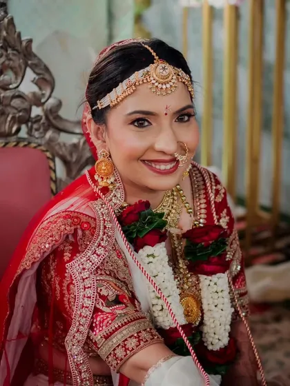 A close-up of a bride, radiant and ready for her ceremony. Her look is rooted in tradition, with classic makeup choices that enhance her features and bring out a graceful glow, timeless as her vows.