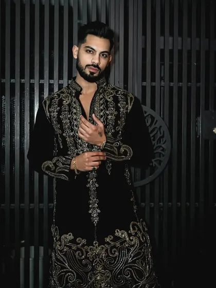 This black velvet kurta set is made for sophisticated celebrations. The exquisite gold handwork glistens with every movement, and the luxurious fabric drapes beautifully, ensuring you are the center of attention at any festive event.