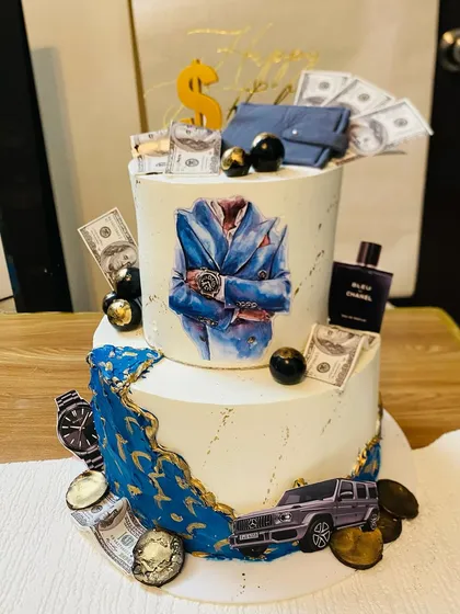 For those who appreciate the finer things, this two-tier luxury themed cake is a perfect choice. It's a multi-layered experience with flavors like couverture chocolate with salted caramel, Nutella hazelnut, and strawberry compote, all coming together for an unforgettable taste.