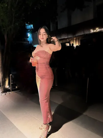 A full-length shot of a pink ruched bodycon dress, a perfect look for a night out.