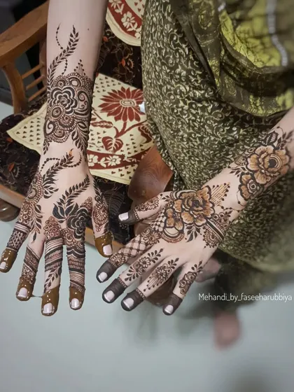 A full view of the floral back-hand henna, showing the artistry and detail.