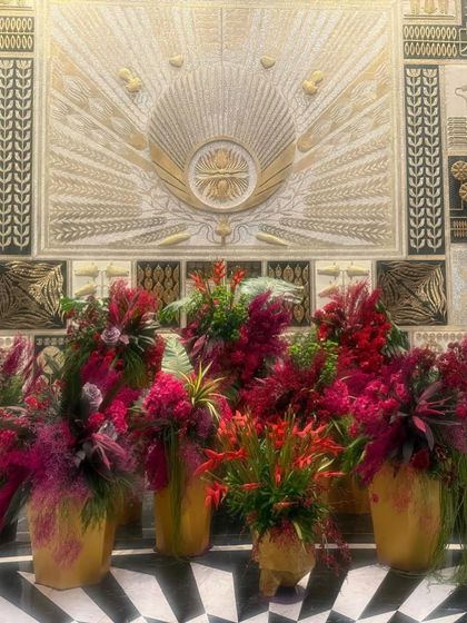 A slightly different angle of the Fairmont lobby decor, showing how the light catches the golden vases and vibrant red flowers.