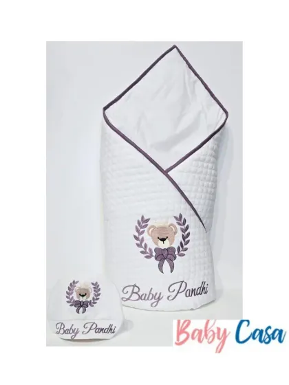 A personalized wrap and cap set for "Baby Pandhi." The design features a teddy bear crest in a lovely lavender and white color scheme, making it a sweet and gentle choice.