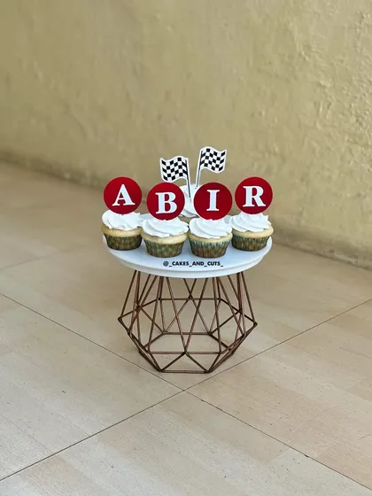 Personalized cupcakes that spell out "ABIR" for his Cars-themed birthday party.