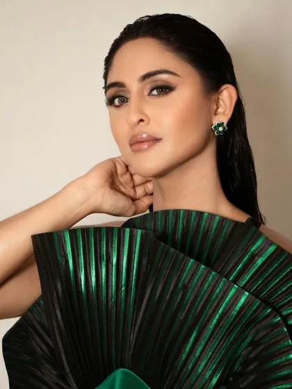 For this signature red carpet look on Krystle D'Souza, I created a sharp, dramatic winged eyeliner and a perfectly blended soft brown smokey eye. The skin is flawless with a matte finish, and the lips are a neutral gloss, ensuring the focus remains on her expressive eyes.