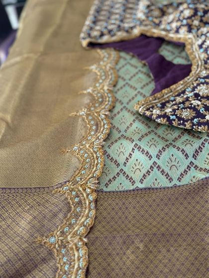 The blouse is paired with a matching embroidered saree border for a complete look.