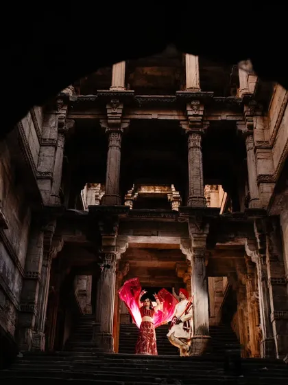 We can create a story that feels both grand and deeply personal. This shot, from a 'Raja & Rani' themed anniversary shoot in a Gujarat stepwell, shows how we can use dramatic architecture and traditional attire to craft a powerful, regal narrative.