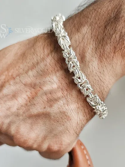 For a bolder statement, we present the King's Chain bracelet. This design features a complex, interlocking weave of pure 92.5 silver, creating a substantial piece that signifies strength and intricate craftsmanship.