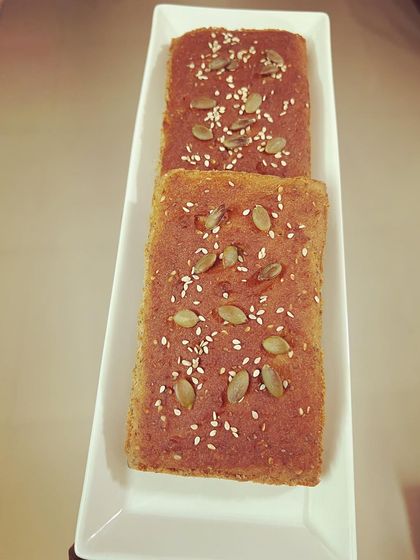 Two freshly baked mini loaves of my lentil bread, topped with sesame and pumpkin seeds. These are perfect for small families or as a healthy gift for a loved one.