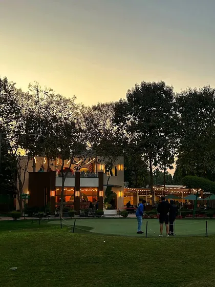 The putting green at sunset, with the cafe lights beginning to glow in the background.