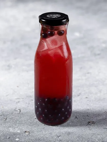 A bottled blueberry beverage for Chili's India. The simple, clean shot on a neutral background is ideal for menu and catalog purposes.