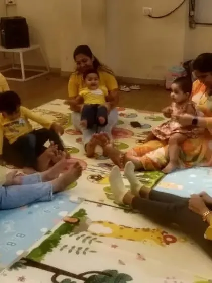This photo captures a gentle moment of parent-child interaction during a song. These quiet, focused activities are just as important as the high-energy dancing for building connection.
