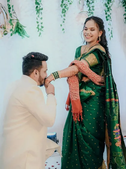 A chivalrous gesture as the groom kisses the bride's hand, her joyful reaction making this a perfect engagement memory.