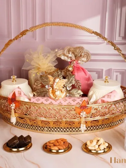 Blessings, light, and sweetness come alive with the Dhan Vardhanam Hamper. This basket includes a Ganesha idol alongside assorted sweets and nuts, making it a thoughtful gift for cherished Diwali celebrations.