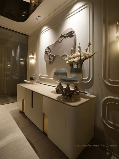 This bespoke crockery cabinet is finished in a smooth PU paint with seamless brass handles. It provides ample storage while serving as a beautiful backdrop for the dining area, complemented by a commissioned multimedia artwork.