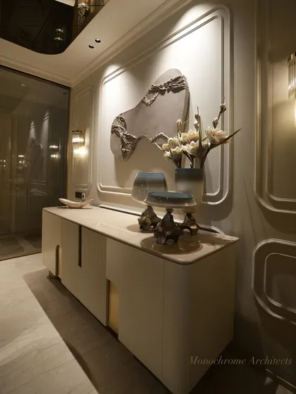This bespoke crockery cabinet is finished in a smooth PU paint with seamless brass handles. It provides ample storage while serving as a beautiful backdrop for the dining area, complemented by a commissioned multimedia artwork.