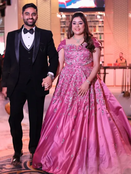 The couple makes their grand entrance. The bride's makeup is flawless and long-lasting, ensuring she looks perfect all night.