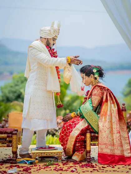 A sacred moment during a Maharashtrian wedding ritual, set against a stunning destination wedding backdrop.
