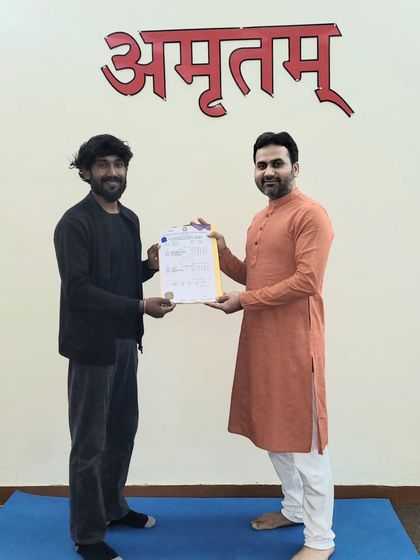 A student receives his 'Yogacharya' certificate. We are proud to support practitioners of all backgrounds in their quest to become teachers.