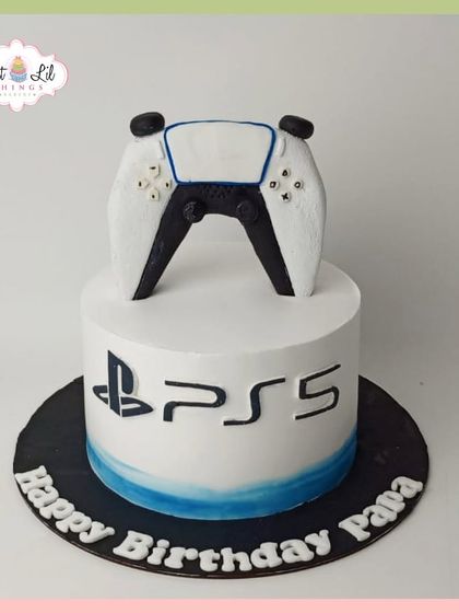 A sleek and modern PS5-themed cake for Papa's birthday, featuring the iconic logo and a detailed controller topper.