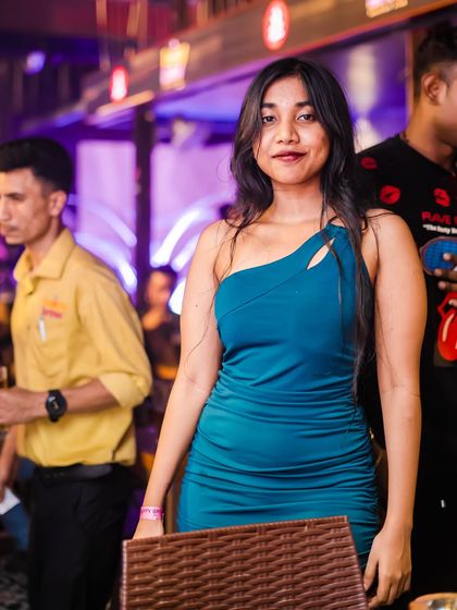 A guest posing for a photo, showcasing her party outfit.