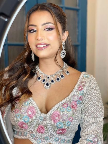 A modern, fashion-forward look featuring a pearl-encrusted gown. The simple diamond drop earrings are the perfect accessory for this statement outfit.