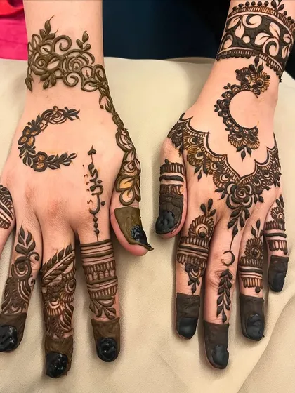 This design shows a mix of modern elements, including a crescent moon, Arabic-style lettering, and bold fingertips.